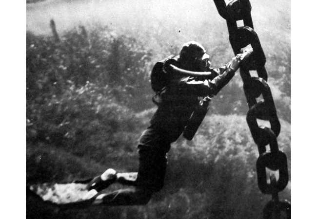 A man holding onto a large chain.